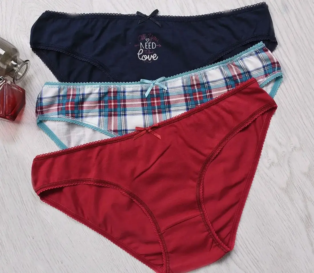 Three pairs of briefs laid flat: navy, tartan and red